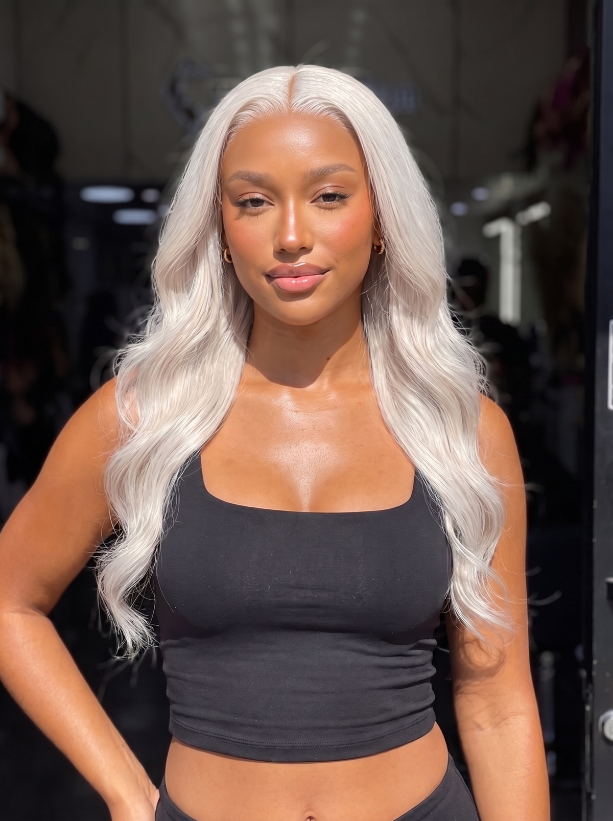 Long wavy platinum-silver lace front wig with center part and full volume