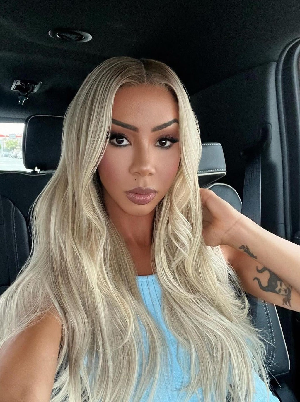 Long blonde lace-front wig, center part, long wavy hair with soft volume