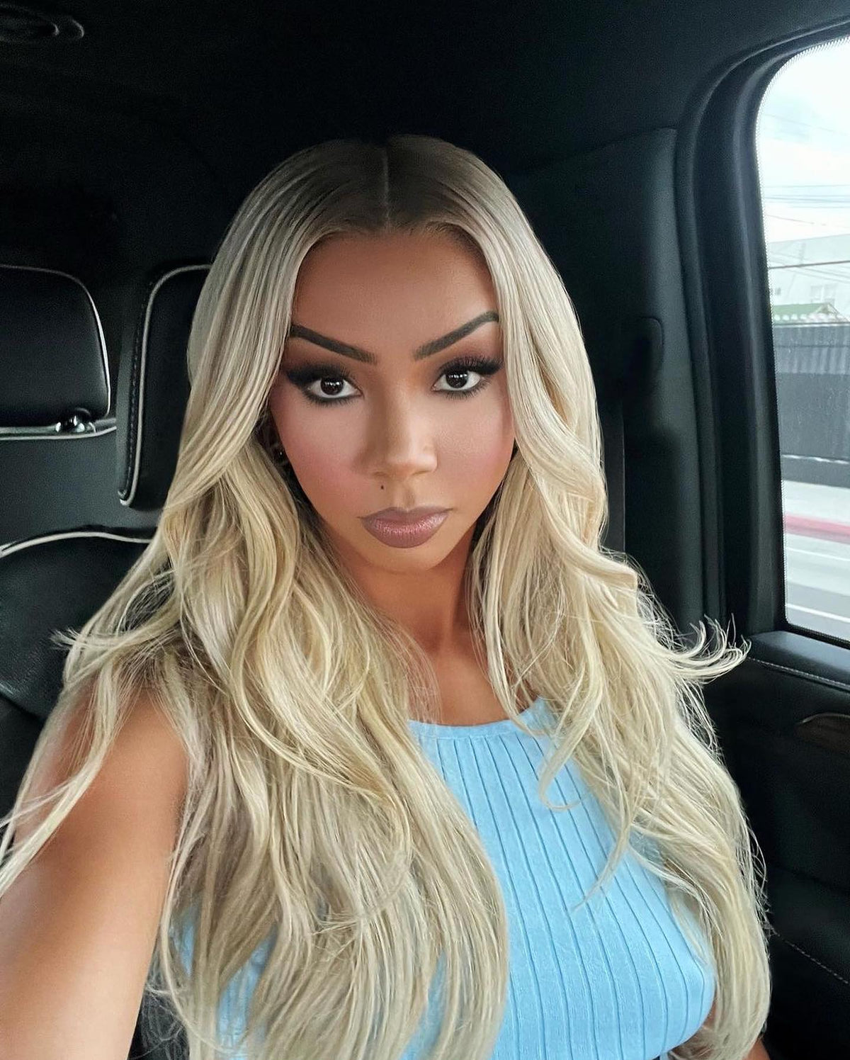 Long blonde lace-front wig with deep center part and loose waves, full coverage