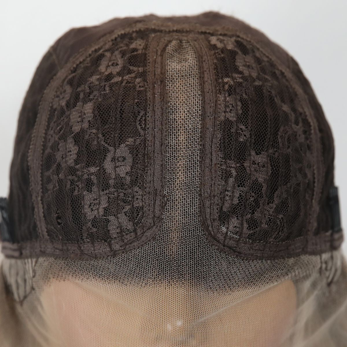 Synthetic wig cap with dark mesh panel and sheer net backing