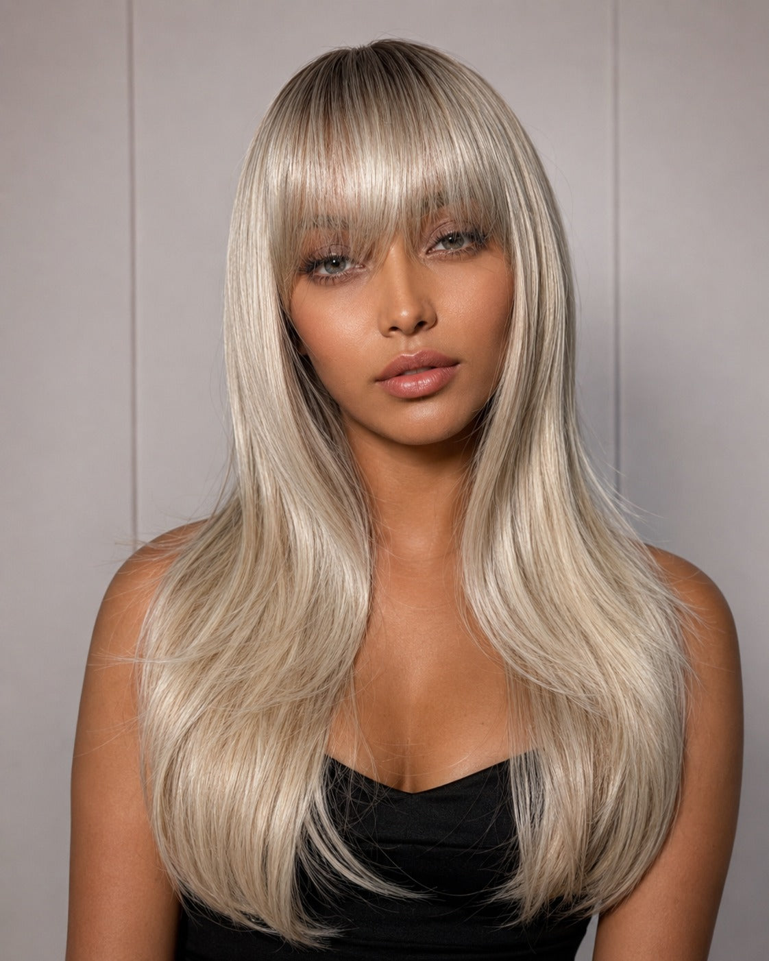 Light ash-blonde long wig with straight strands and blunt bangs framing face