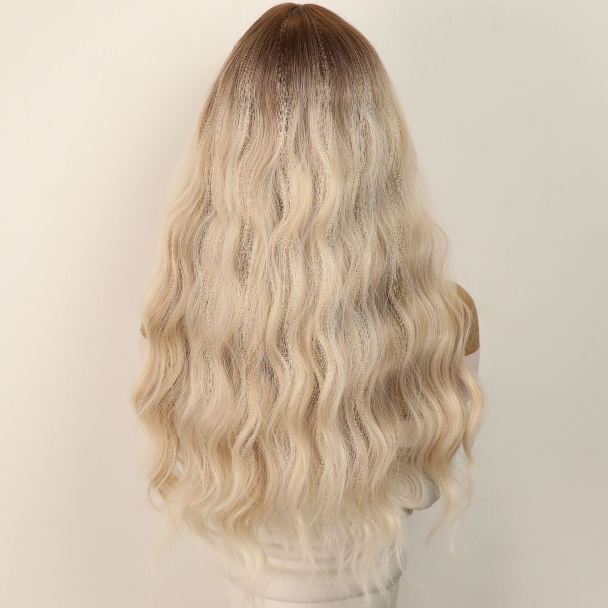 Long blonde wavy synthetic wig with dark-root crown, full volume