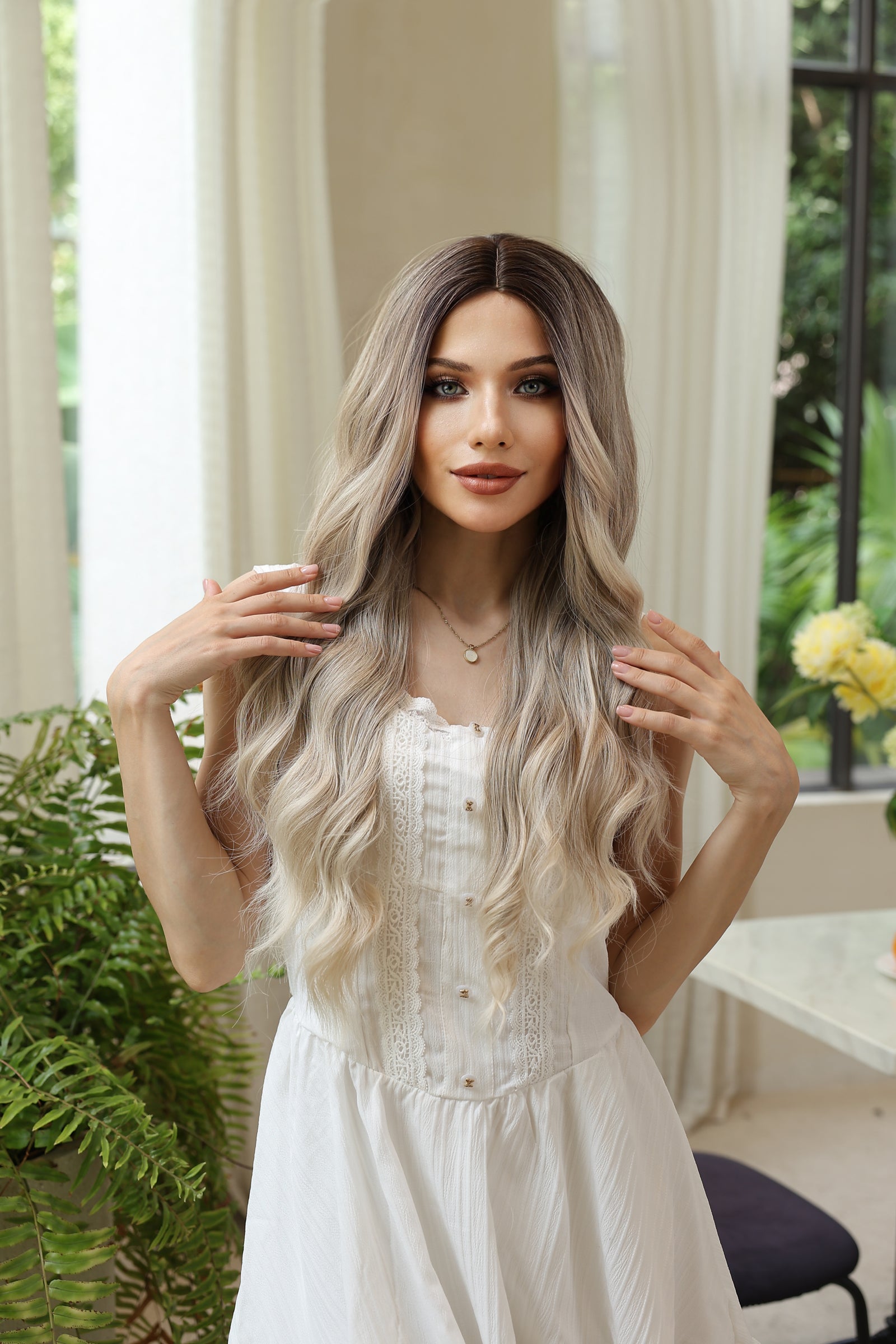 Long wavy blonde wig with darker roots, center part, layered face-framing strands