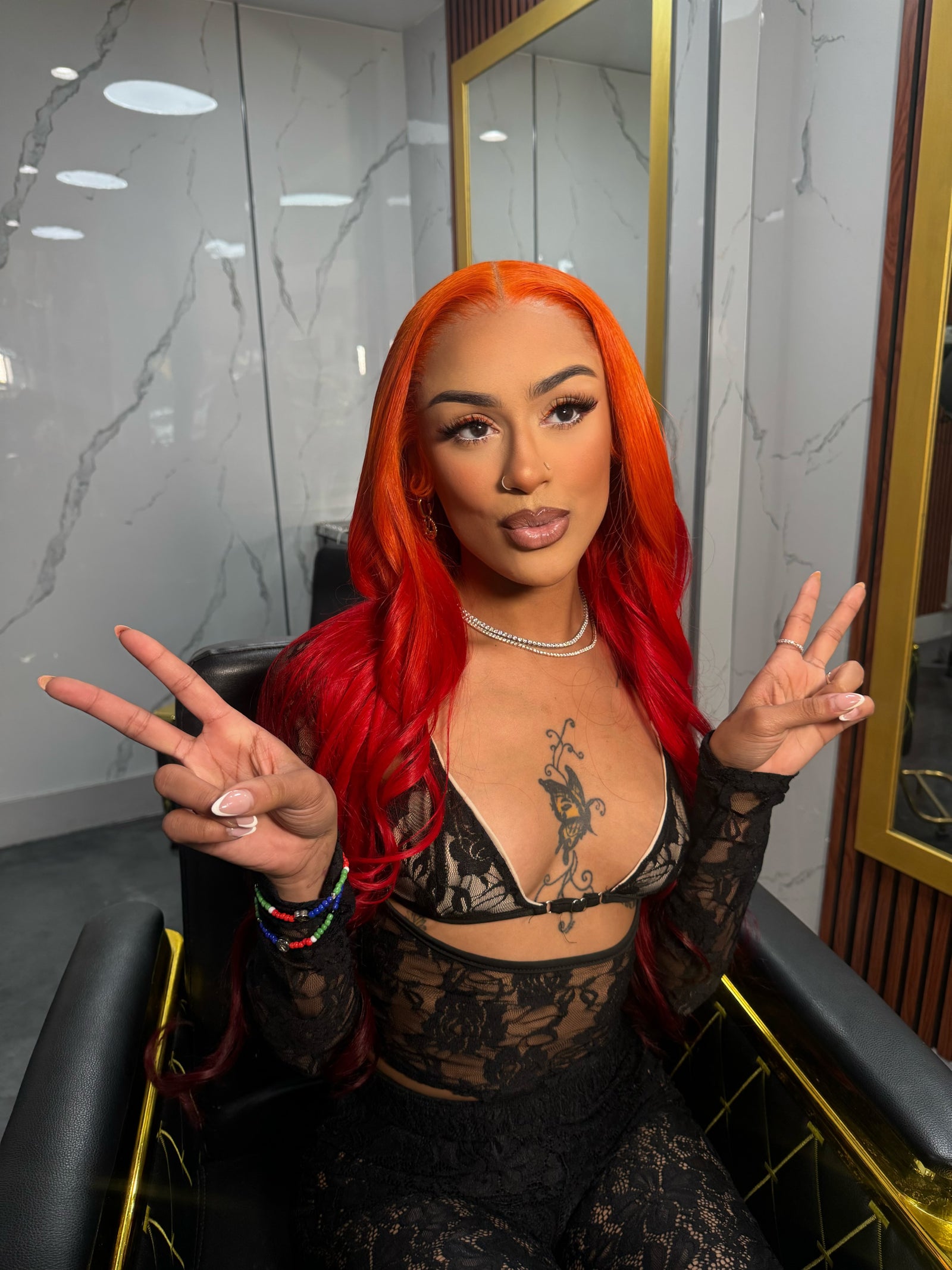 Bright red lace wig with long hair, visible lace front and side part, close-up.