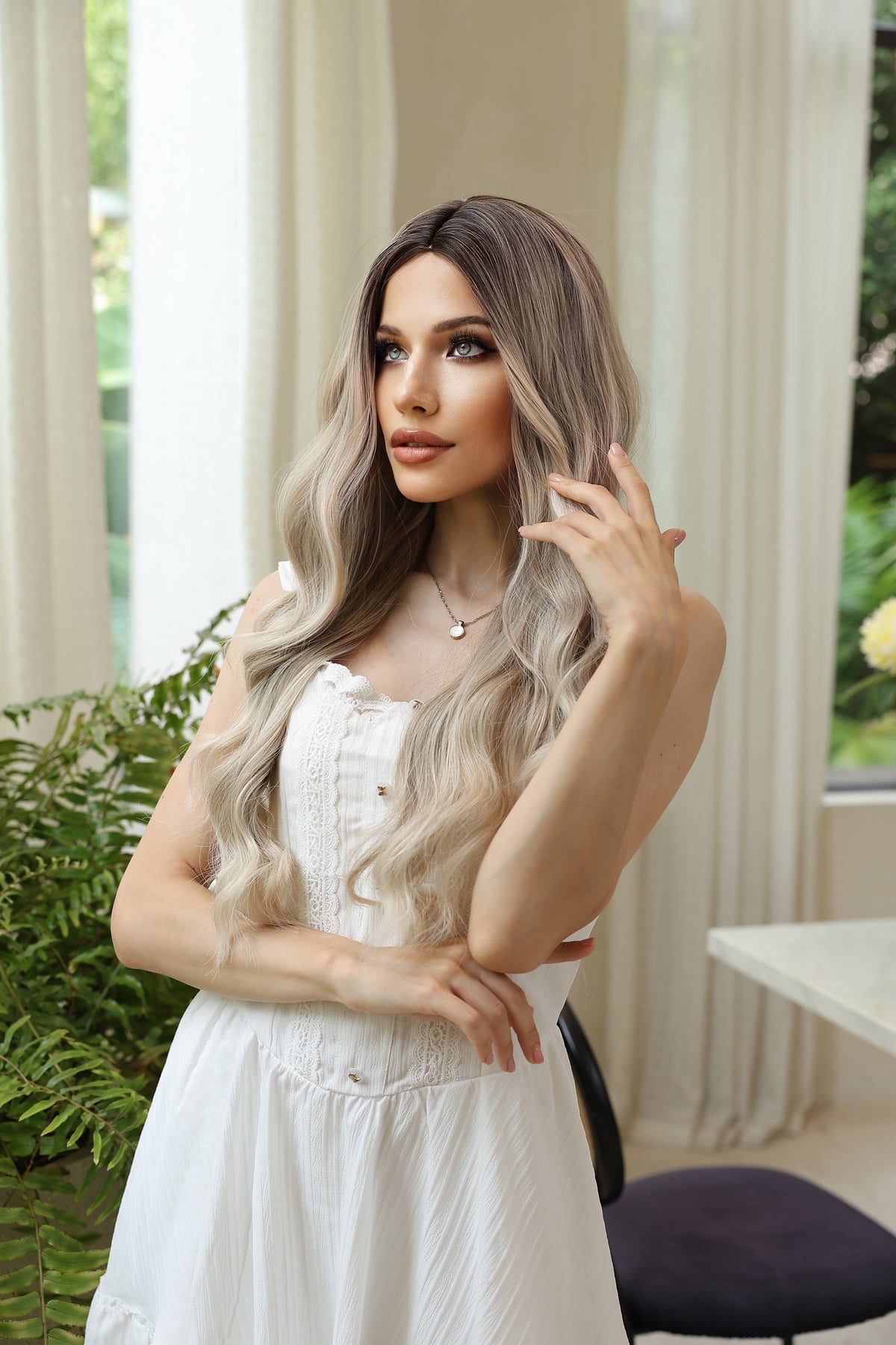 Long wavy blonde wig with dark roots, center part, face-framing highlights
