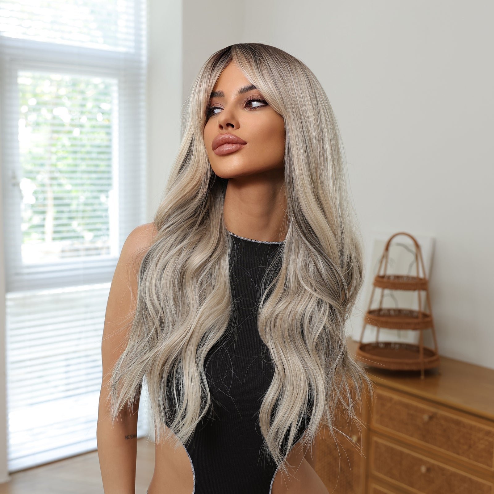 Long icy blonde wig with curtain bangs and loose wavy layers framing face