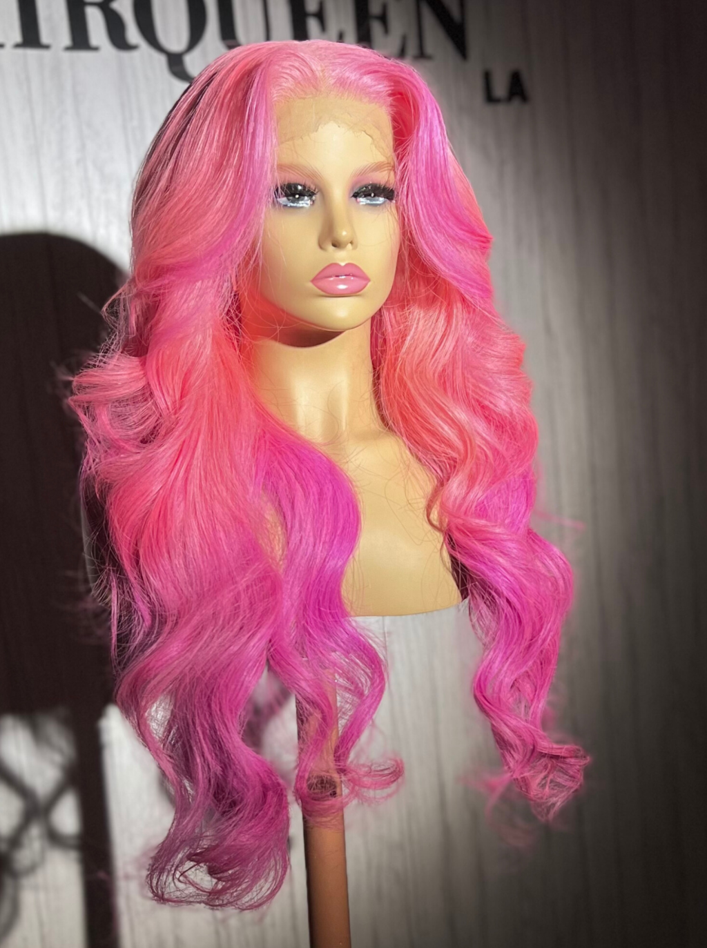 Long pink wavy wig with center part on mannequin head, full coverage