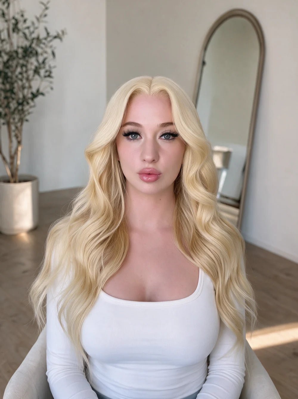 Long blonde wig with soft waves and middle part on model