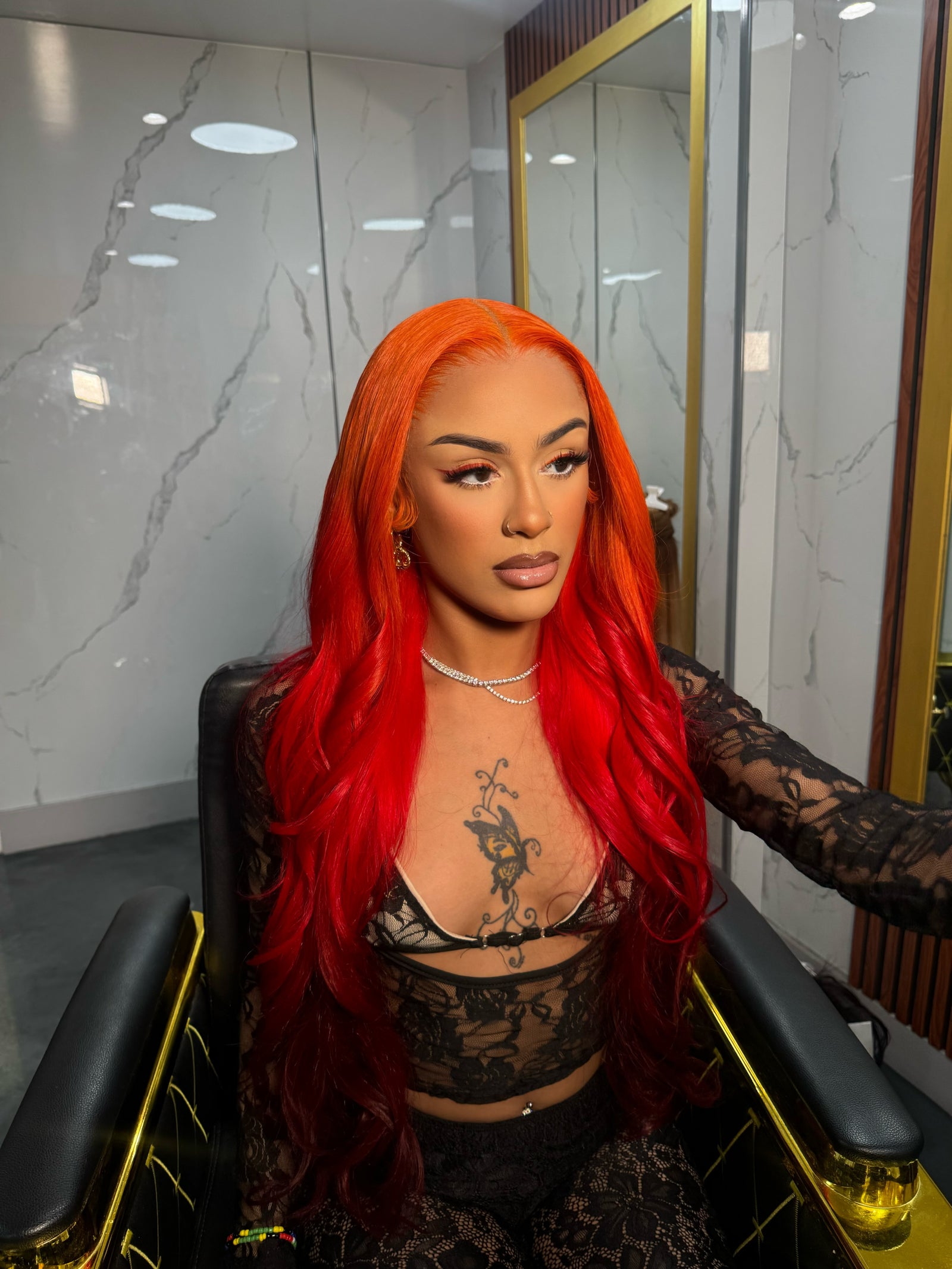 Bright red lace wig with long loose waves and side part, styled for front view.