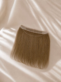 Brown hair topper with transparent lace top edge and natural-looking straight strands