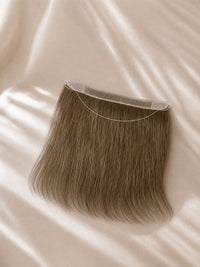 Lace hairline topper with natural brown hair strands and sheer lace hairline base