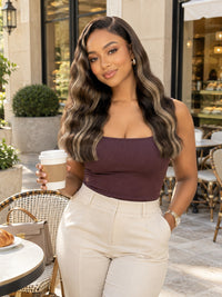 Wavy dark lace frontal worn by model, shoulder-length curls with natural hairline.