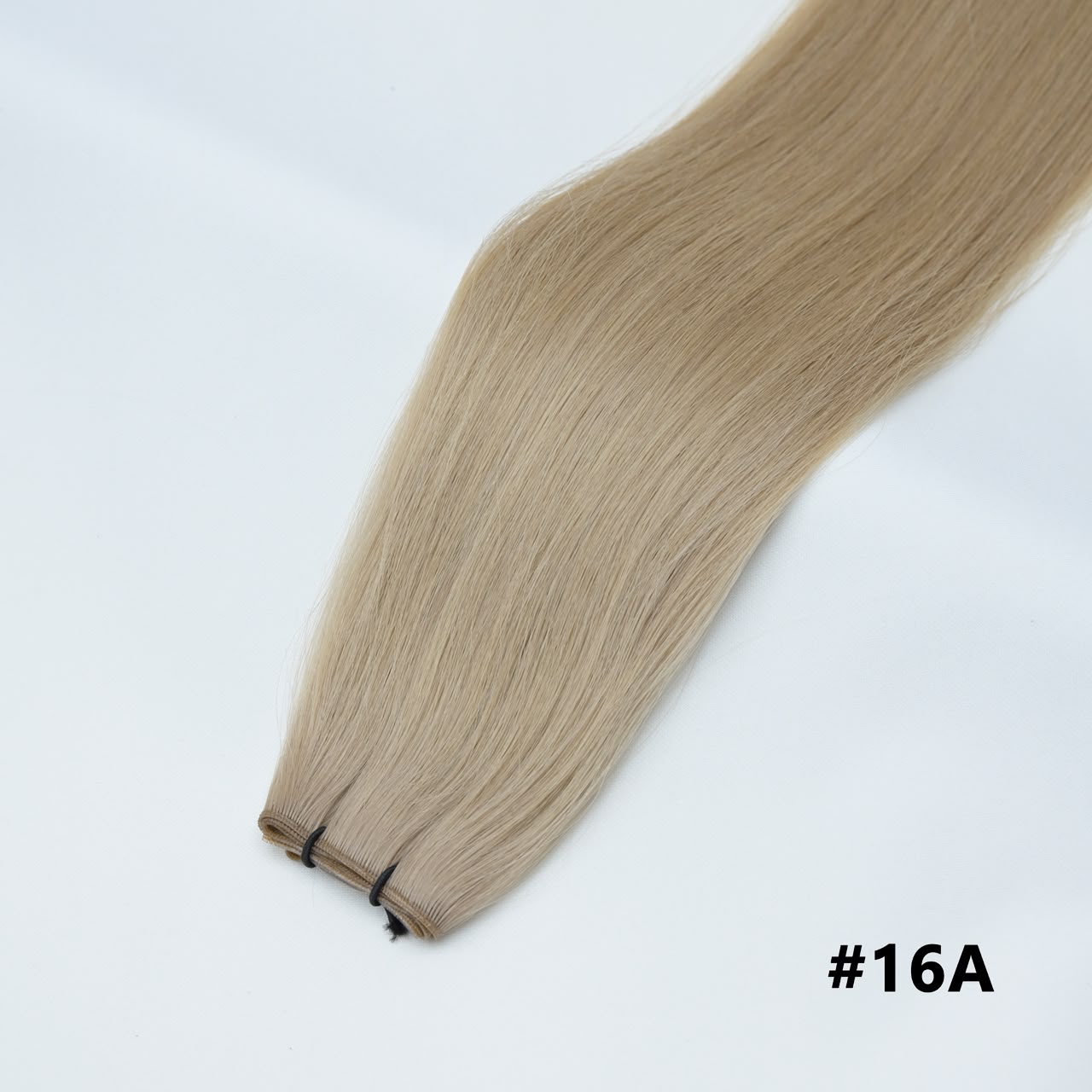 Tape-in hair extensions, straight strands in beige blonde #16A with visible tape clips