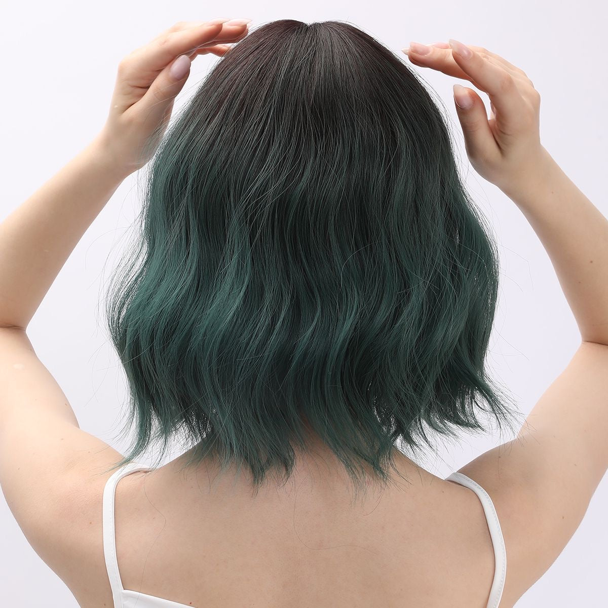 Emerald green short wavy bob wig shown from back with layered ends