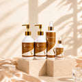 Hair care extension kit with four bottles and gold pump tops on display