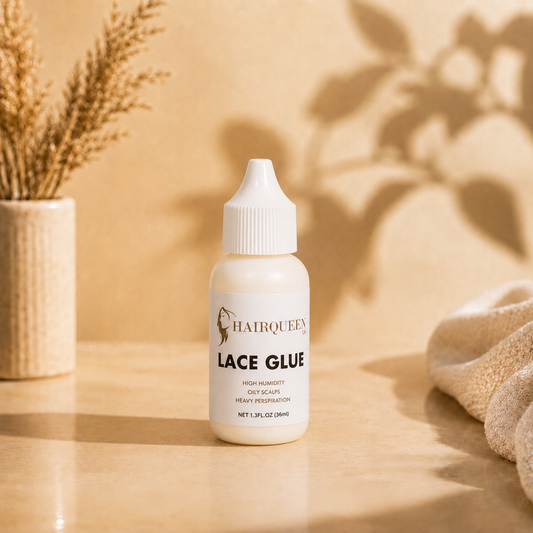 Hair Queen LA Lace Glue bottle on a tabletop with soft gold fabric drape