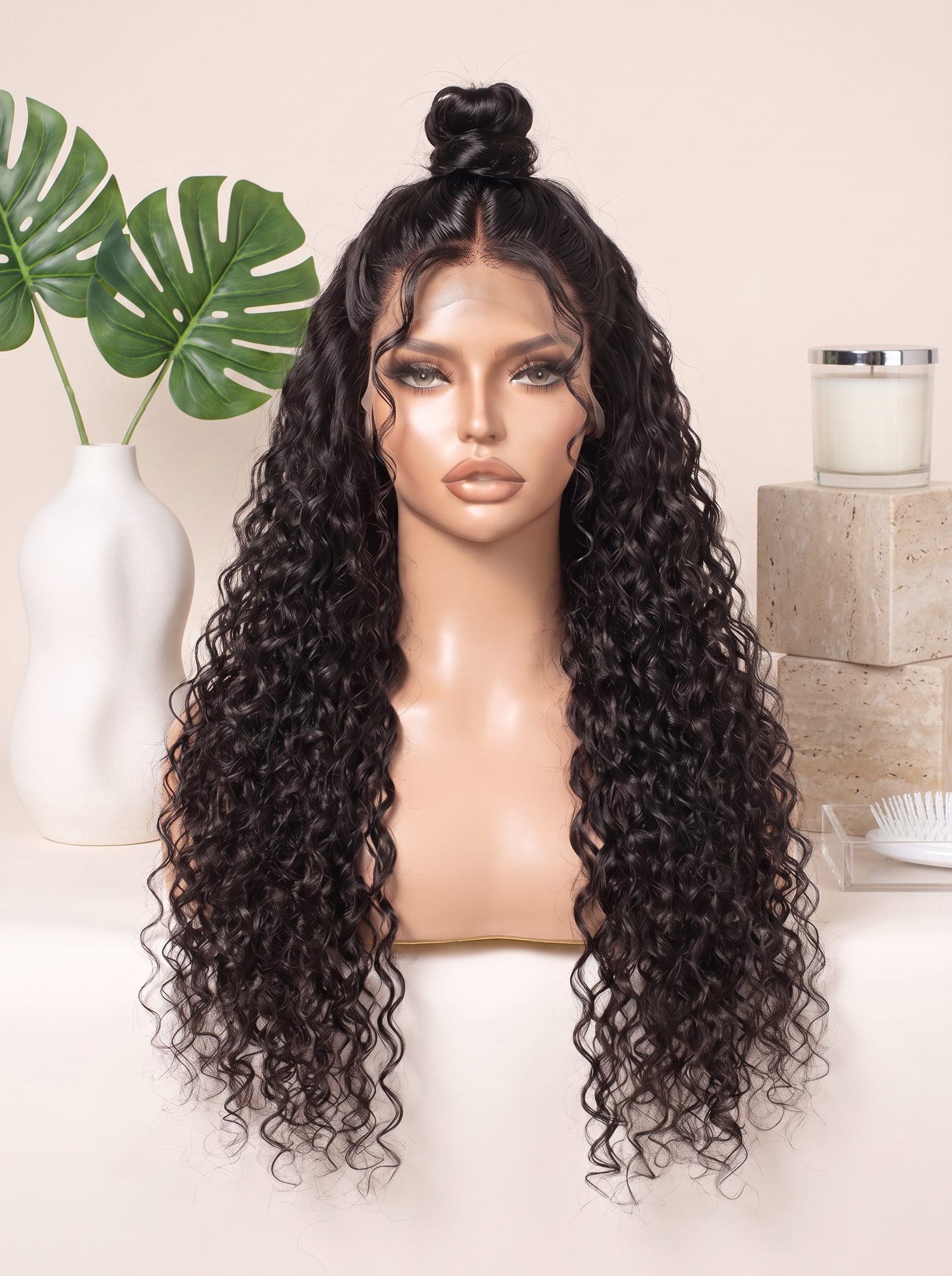 Curly lace wig with long dark ringlets and top knot style on display head