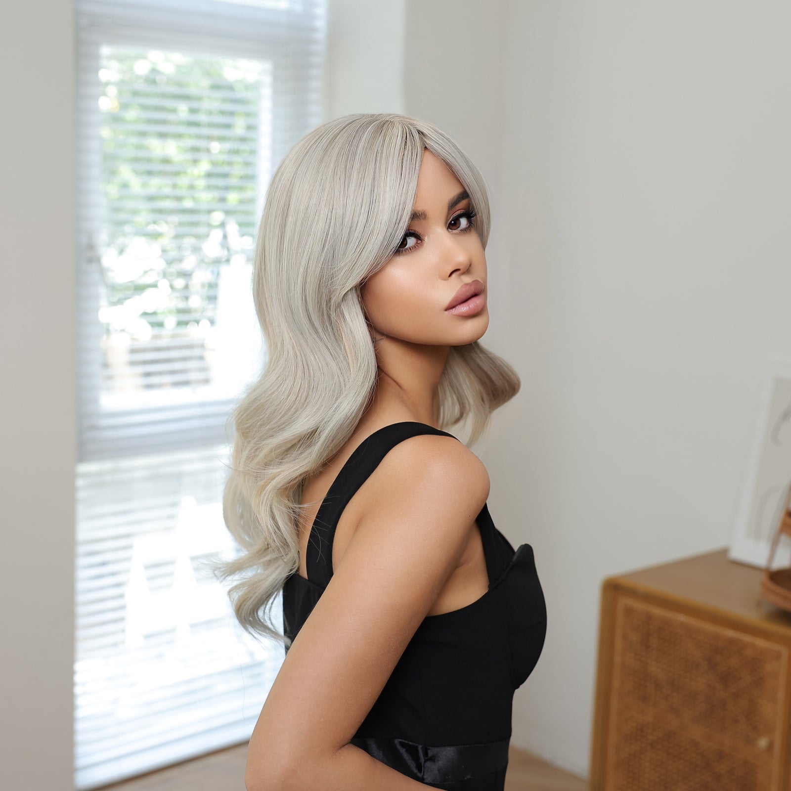 Synthetic blend wig with ash blonde side-swept waves and curtain bangs