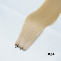 Tape-in hair extensions, straight strands in light blonde #24 with visible tape clips
