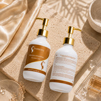 Two Hair Queen LA conditioner bottles with gold pumps, white bottles and amber front labels