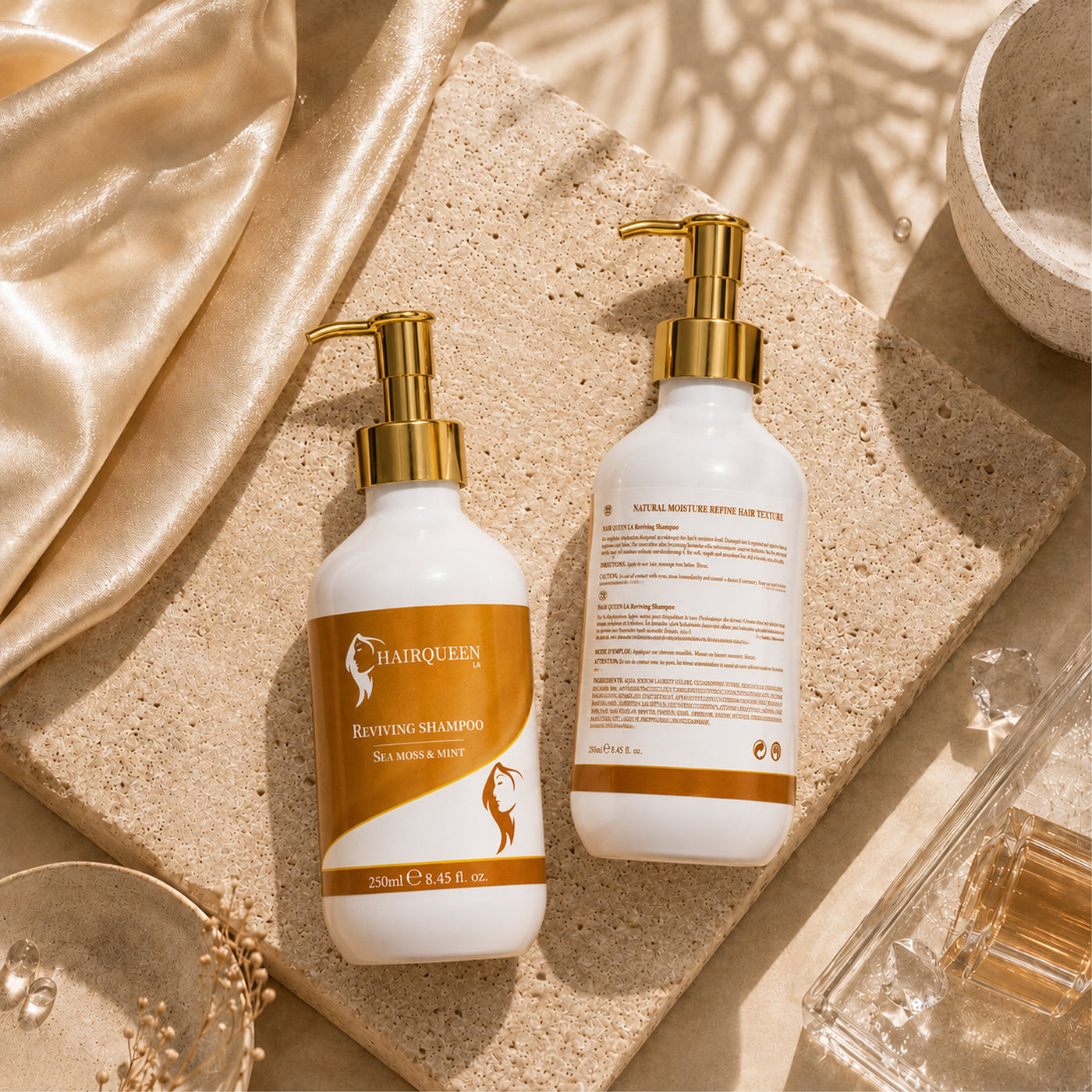 Reviving shampoo bottles set with gold pumps; white bottles with orange label text