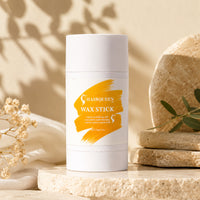 White HAIRQUREEN wax stick tube on stone slab with orange WAX STICK label