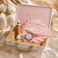 Hair care gift case with lid, pink bonnet, HAIRQUEEN spray bottle, and edge control jar