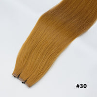 Tape-in hair extensions, straight strands in copper blonde #30 with visible tape clips