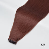 Tape-in hair extensions, straight strands in chestnut red #34 with visible tape clips