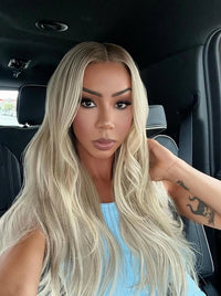Long wavy blonde wig with center part, cool-toned strands and soft volume