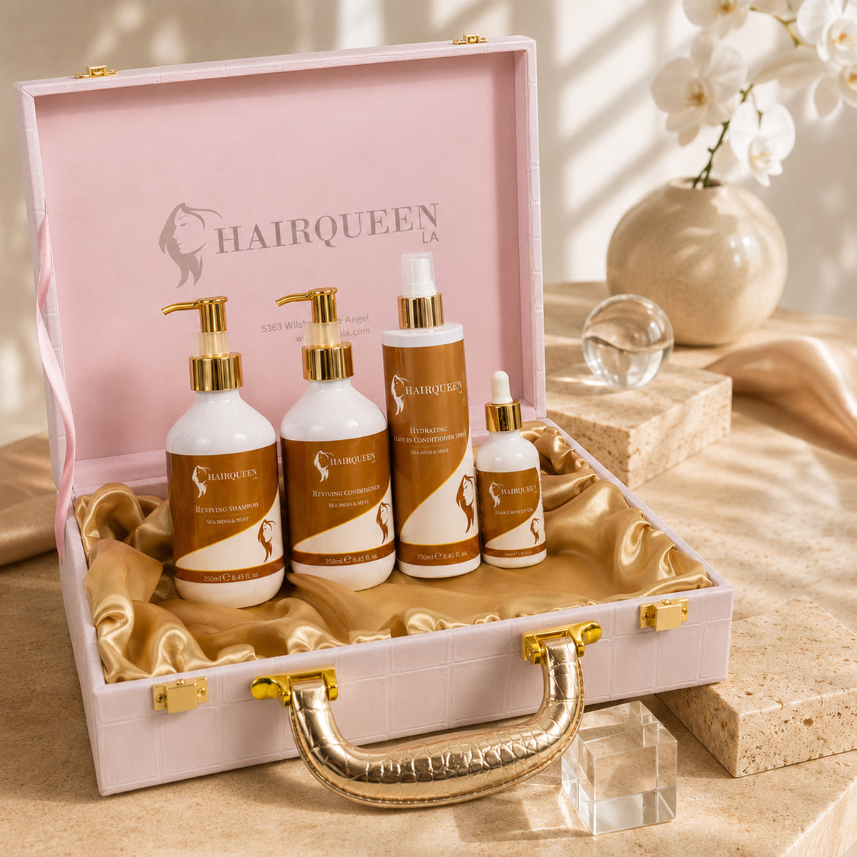 HAIRQUEEN hair care bundle kit open in white case with gold hardware; 5 pump bottles