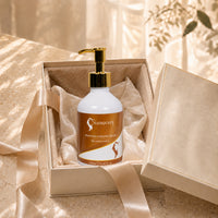 Curl cream bottle with gold pump in open gift box, white bottle with orange label