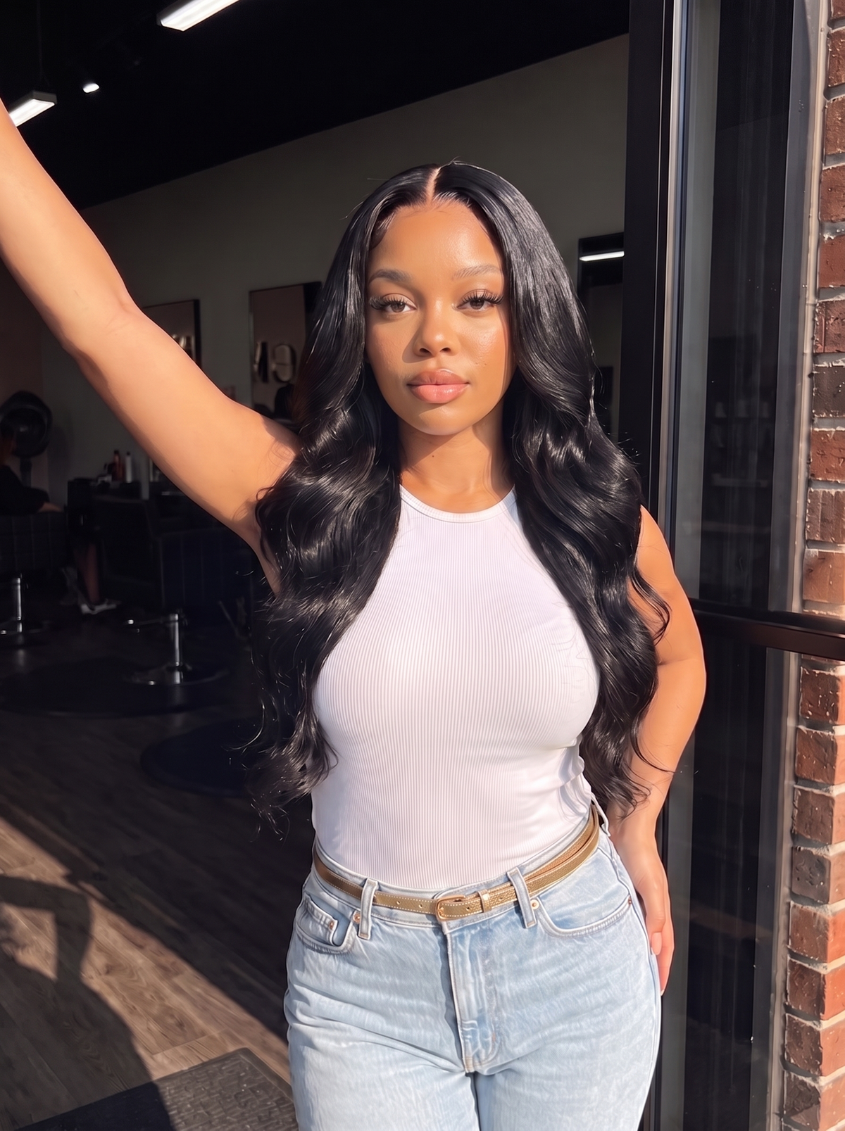 Black long wavy lace wig with deep side part, worn by model