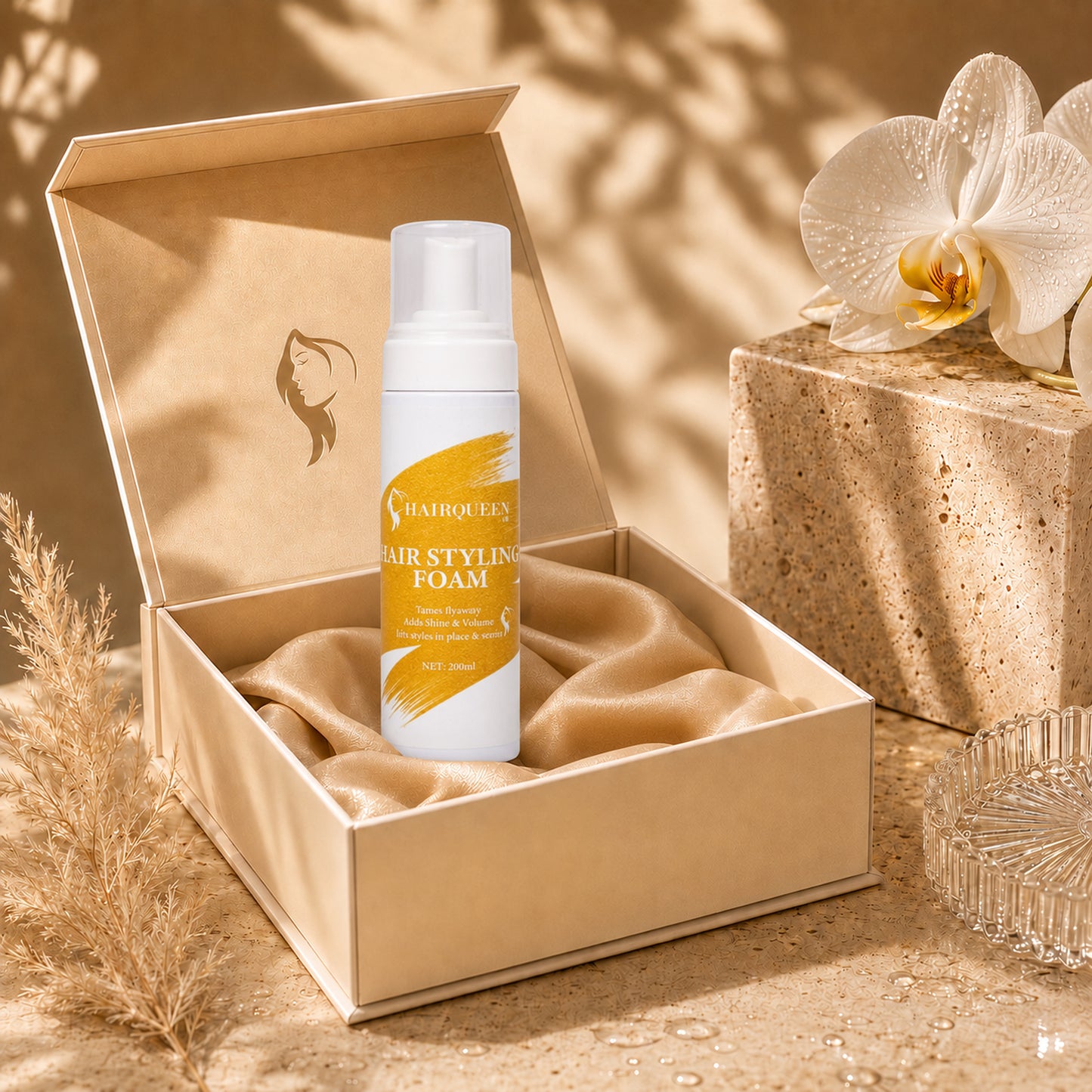 HQLA hair styling foam bottle standing in an open gift box with orchid