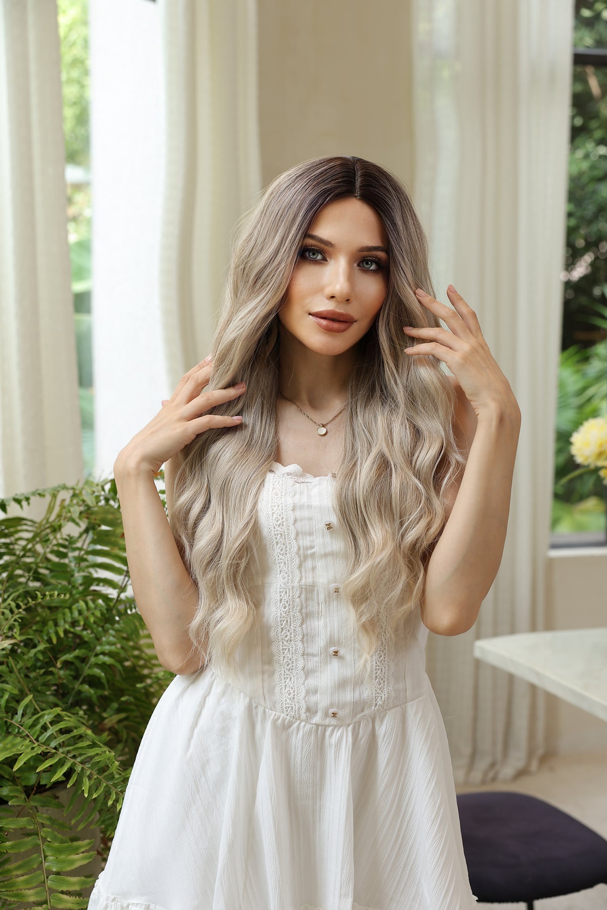 Long wavy synthetic wig with dark-root blend to light blonde, soft waves