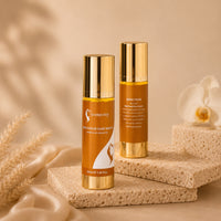 Hair repair serum bottles, amber-orange glass with gold caps on textured stone block