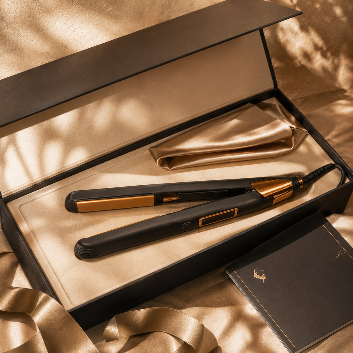 Hair straightener flat iron with black body and gold plates inside open box