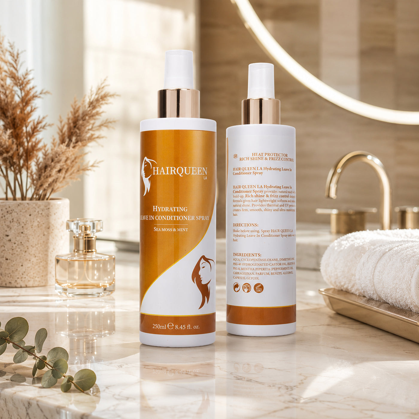 Hydrating leave-in conditioner spray bottles, front orange bottle and back label bottle; white caps