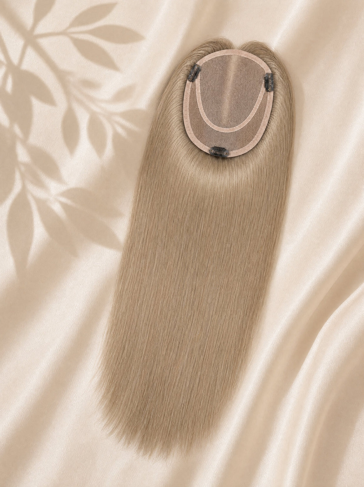 Light blonde mono hair topper with circular monofilament base and attachment clips