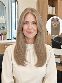 Light ash blonde mono hair topper worn by woman with long straight hair and center part.
