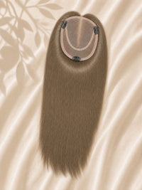 Light blonde mono hair topper underside with monofilament base and clip tabs
