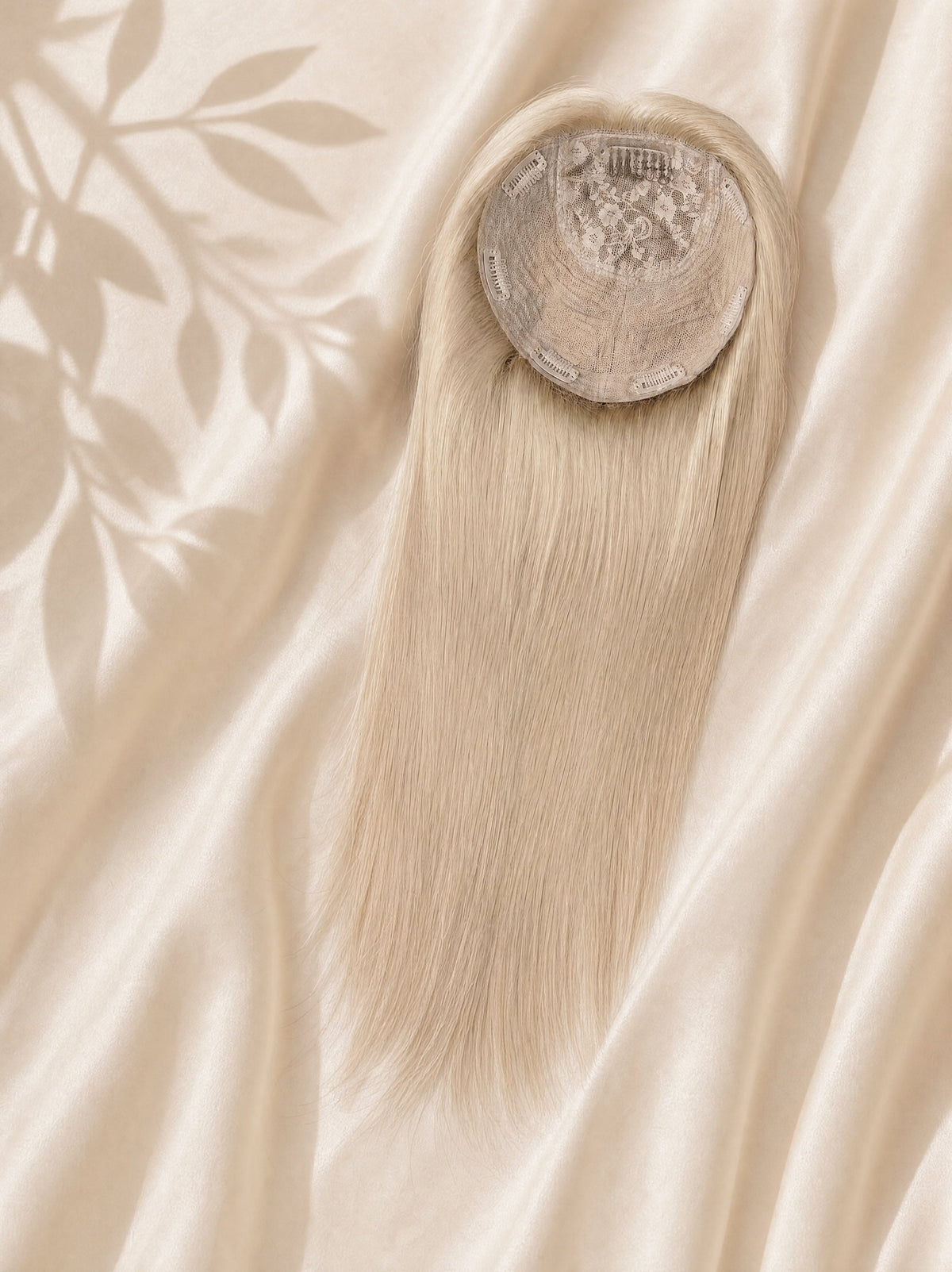 Circular silk base topper with long straight blonde hair, top opening visible.