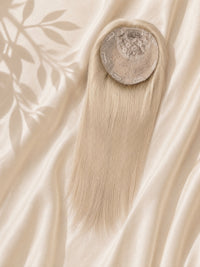 Circular silk base topper with long straight blonde hair, top opening visible.