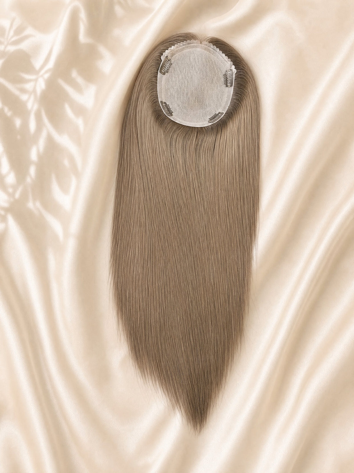 Silk skin hair topper with light gray-brown straight strands and circular clip base