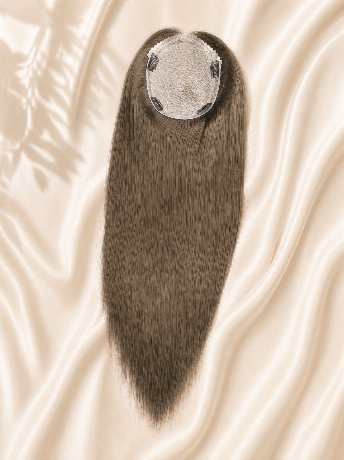Silk skin hair topper with dark gray-brown straight strands and circular clip base