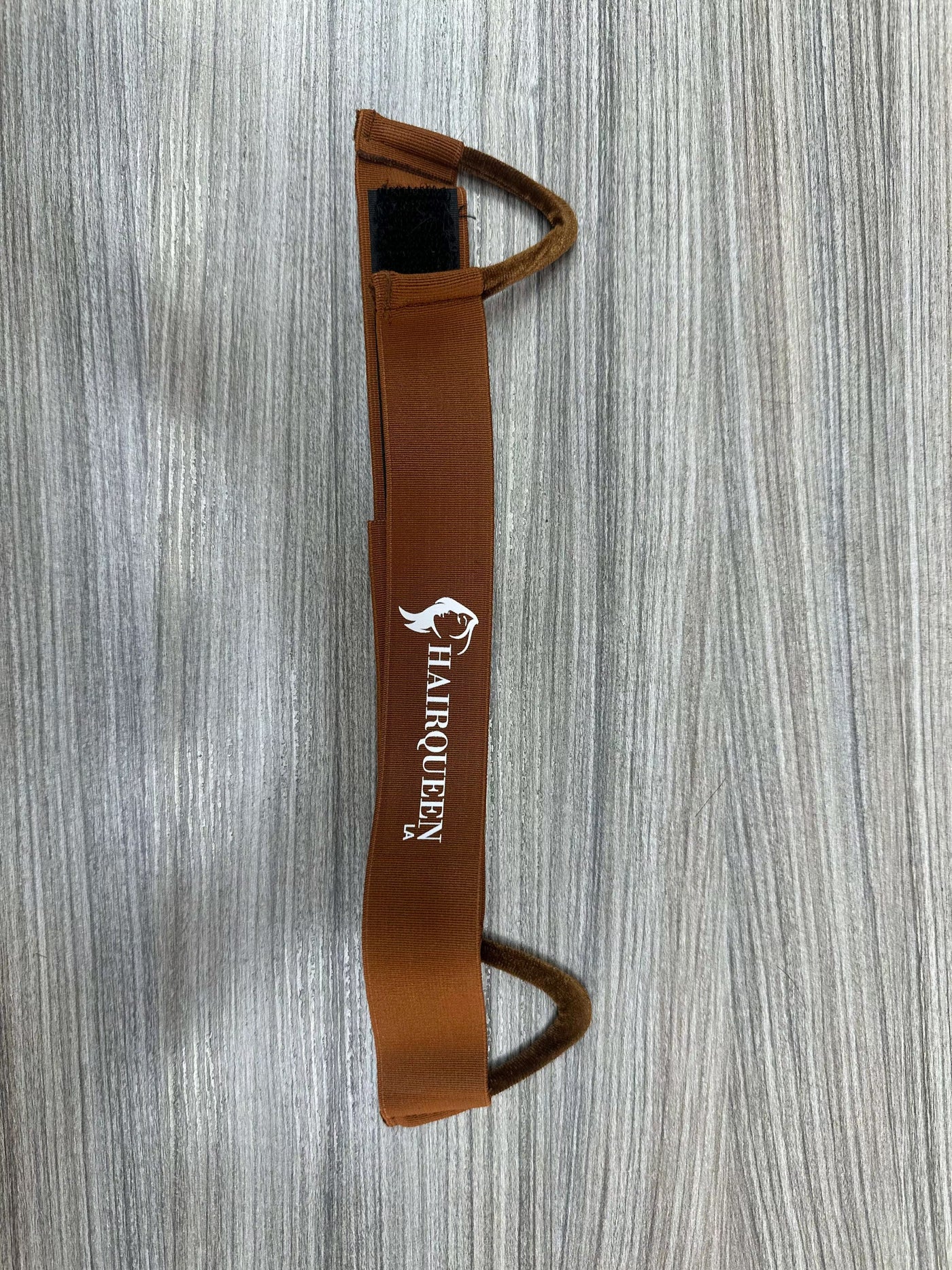 Brown wig band with HairQueen logo, vertical view, two securing loops on ends
