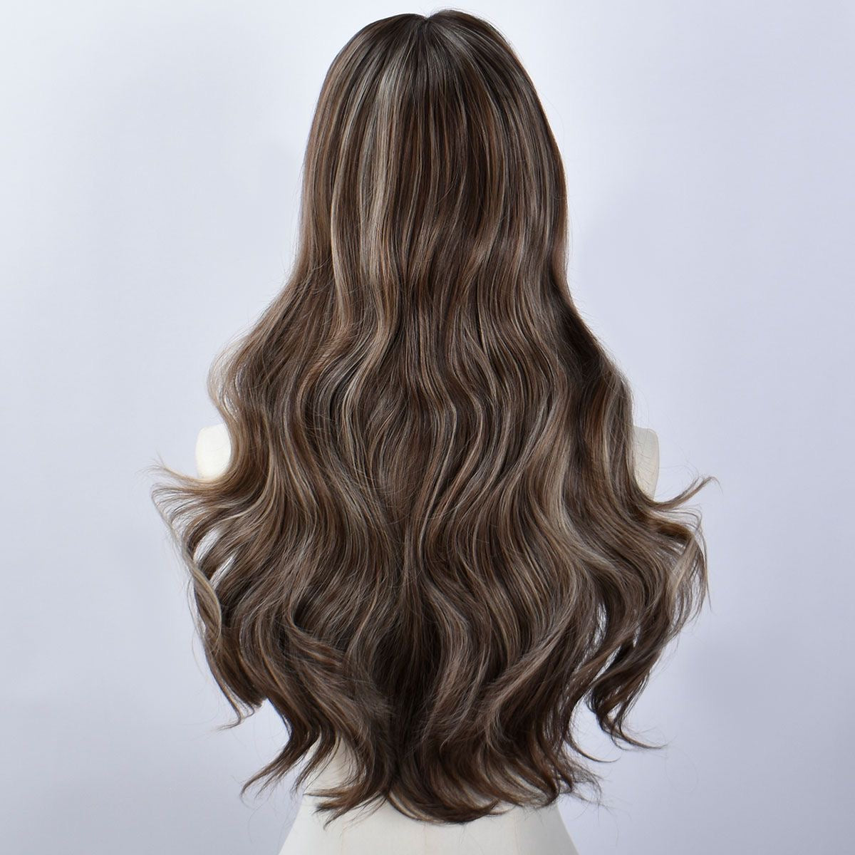 Back view of long synthetic wig with dark brown wavy curls and subtle blonde highlights