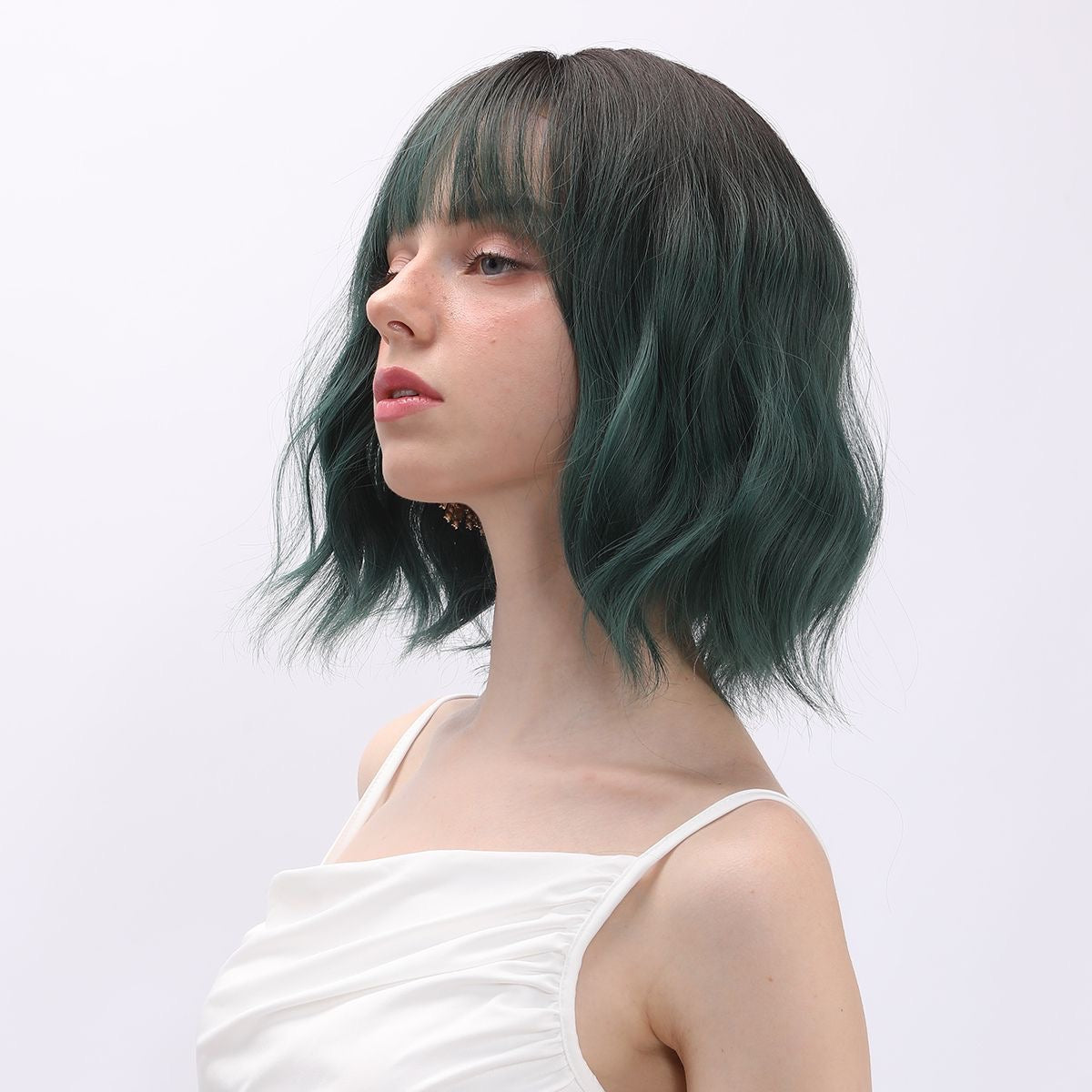 Emerald green short wavy bob wig with bangs, side profile on model