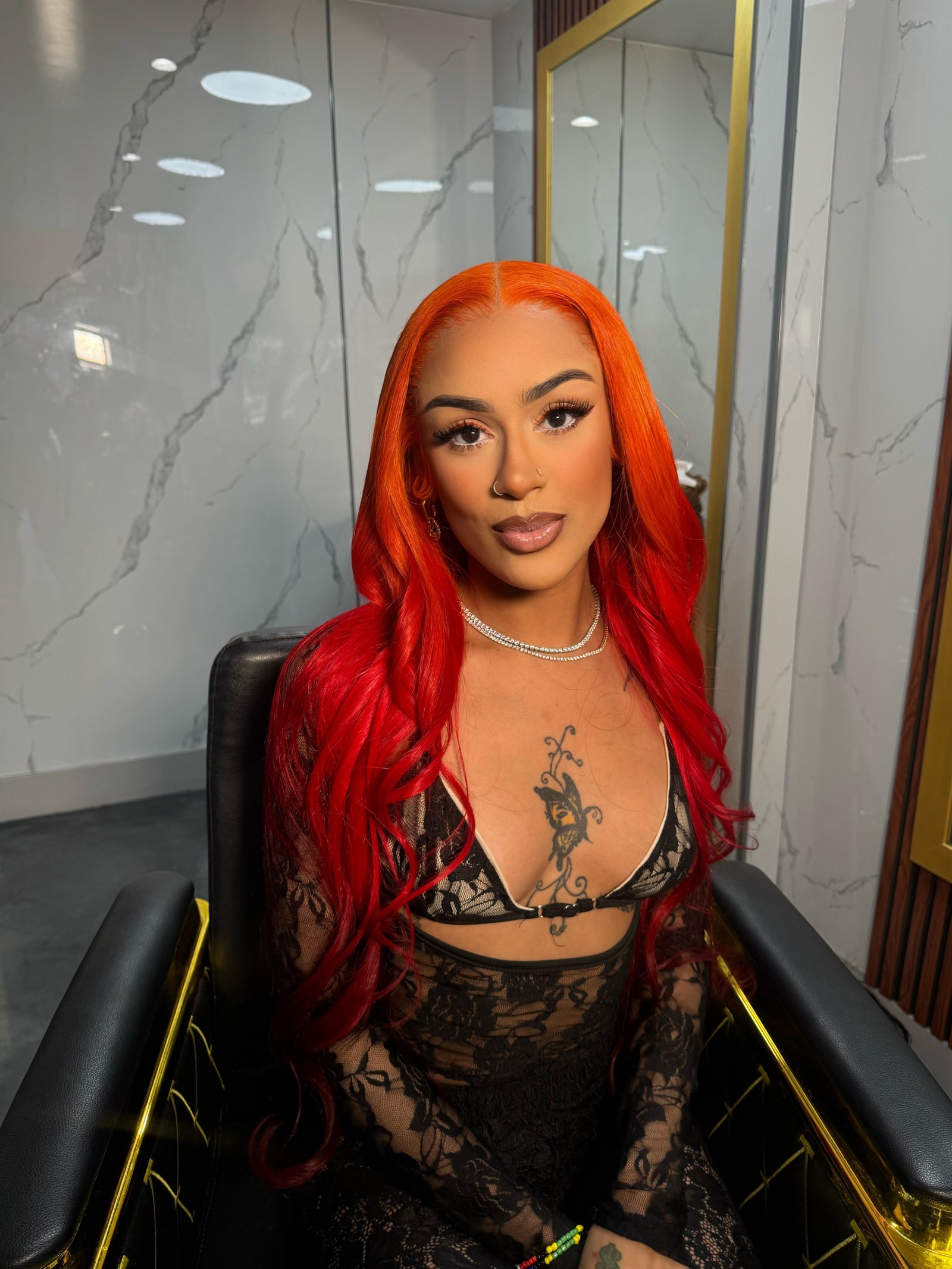 Bright red lace wig with long wavy hair and center part, front-facing.