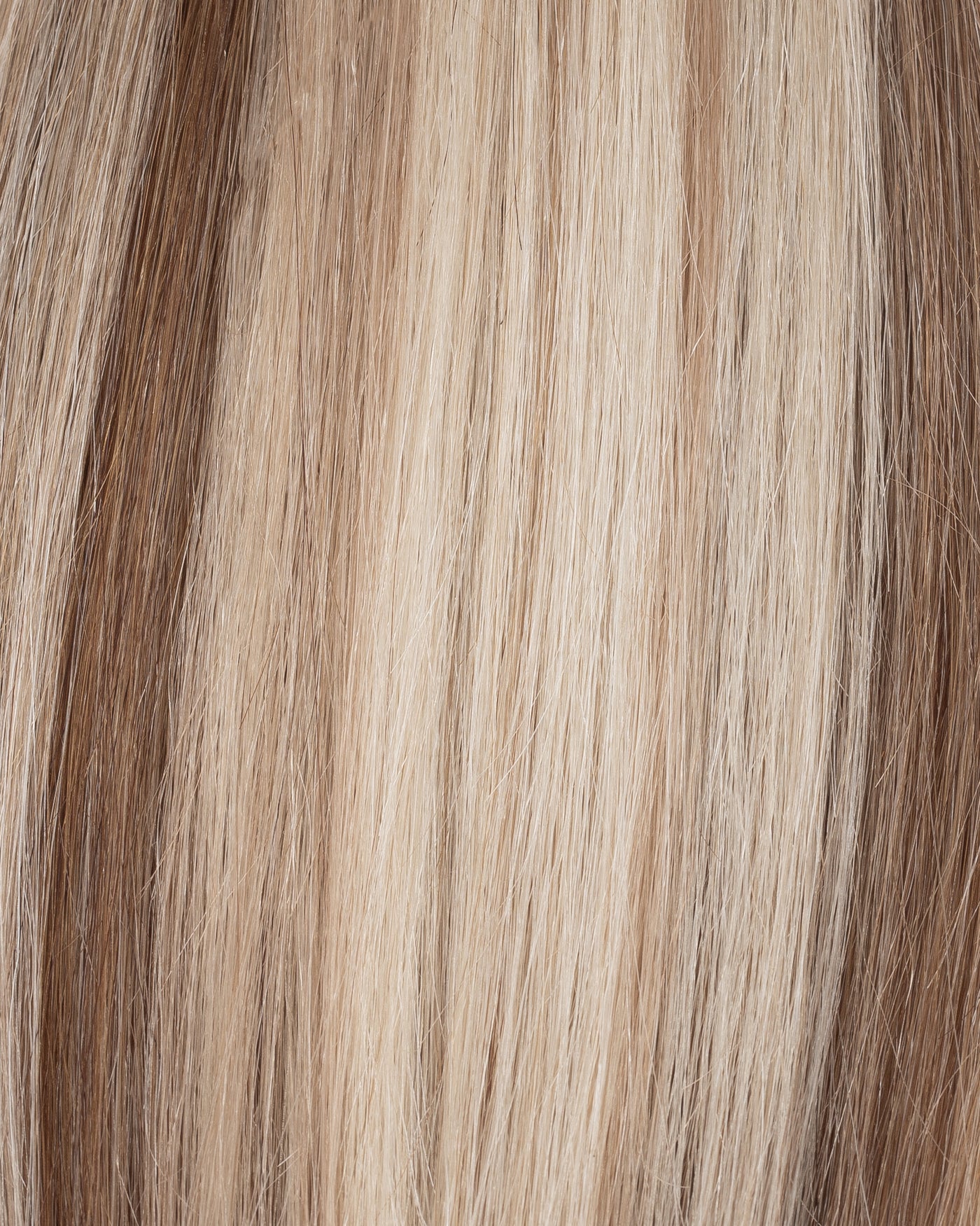 Blonde blend hair strands close-up with fine, straight texture
